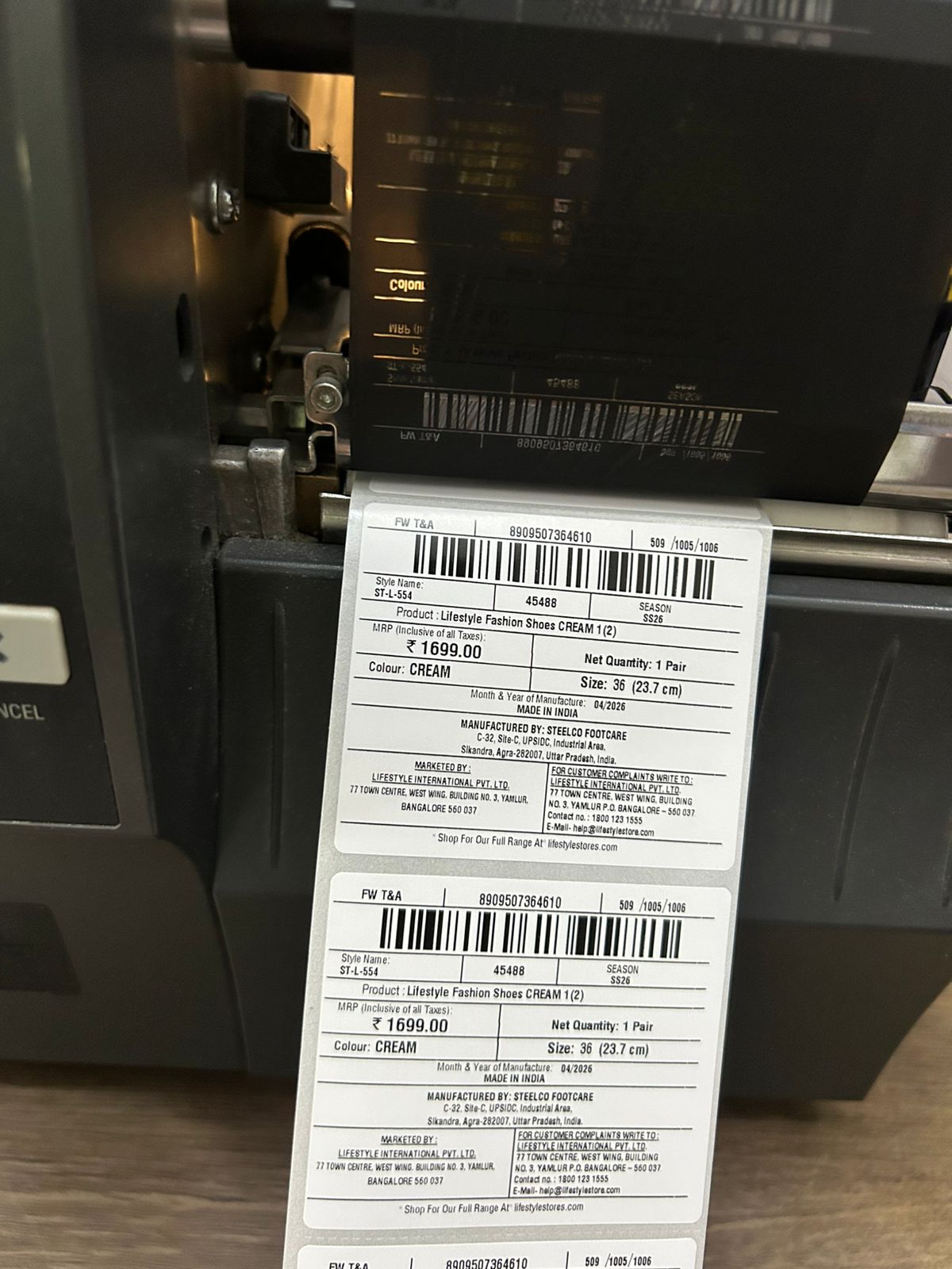 A printed label proof running out on the production material before sign-off